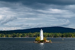 Sun Breaks Through Clouds by Loon Island Light in NH